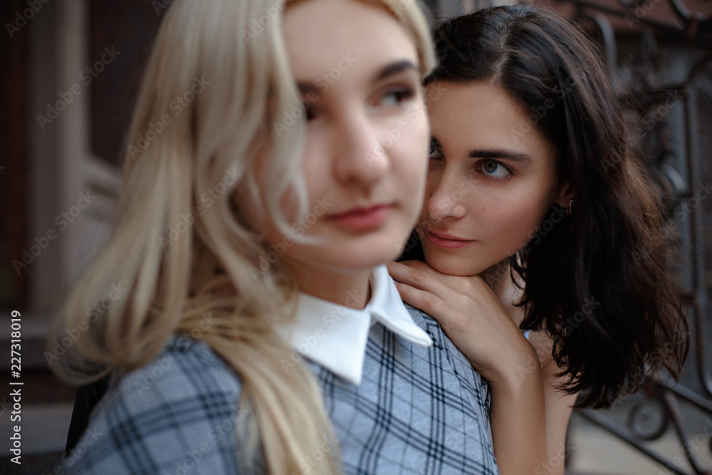 Two attractive young lesbians. Looking somewhere aside. Samesex love concept. Two attractive young lesbians. Looking somewhere aside. Samesex love concept.