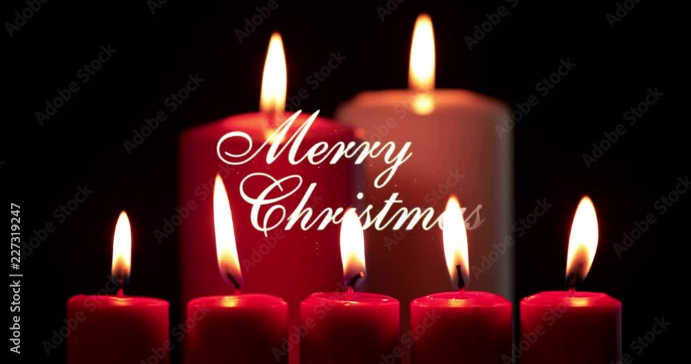 Red Christmas candles and Merry Christmas text on dark background in the studio. Shot in 4k resolution Red Christmas candles and Merry Christmas text on dark background in the studio. Shot in 4k resolution