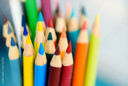 Multicolored pencils on wooden background. Many beautiful multicolored pencils on the table. Pencils for coloring, Creativity.