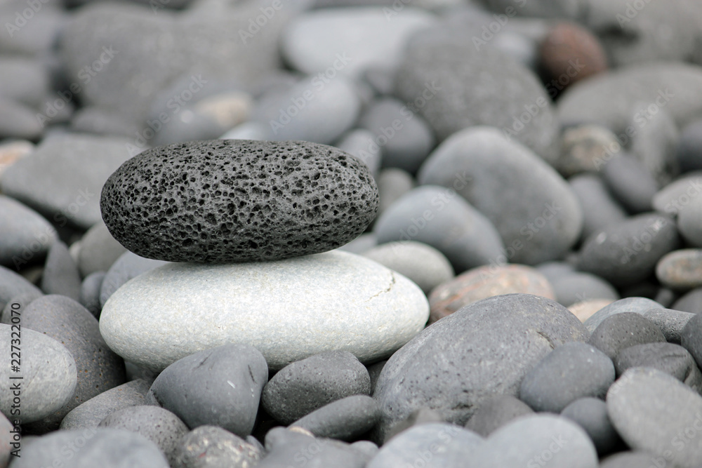 Black stone on white stone. Balanced stones. Black stone on white stone. Balanced stones.