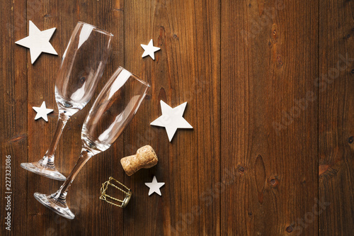 New year's Eve champagne glass and wihte stars on old wooden floor