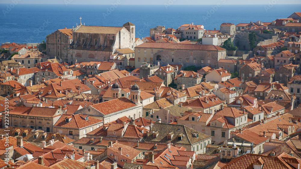 View of the historic city of Dubrovnik. View from the city walls to the medieval old town, buildings dating from the Middle Ages located by the sea. A frequent place of turistic tours.