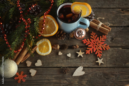 christmas hot mulled wine with cinnamon cardamom and anise on wooden background