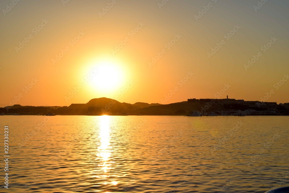 Sunset over hurghada, red sea, Egypt, sunset in front of the ocean over an island