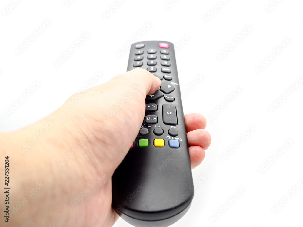 Hand holding a remote control TV isolated on white background. Hand holding a remote control TV isolated on white background.