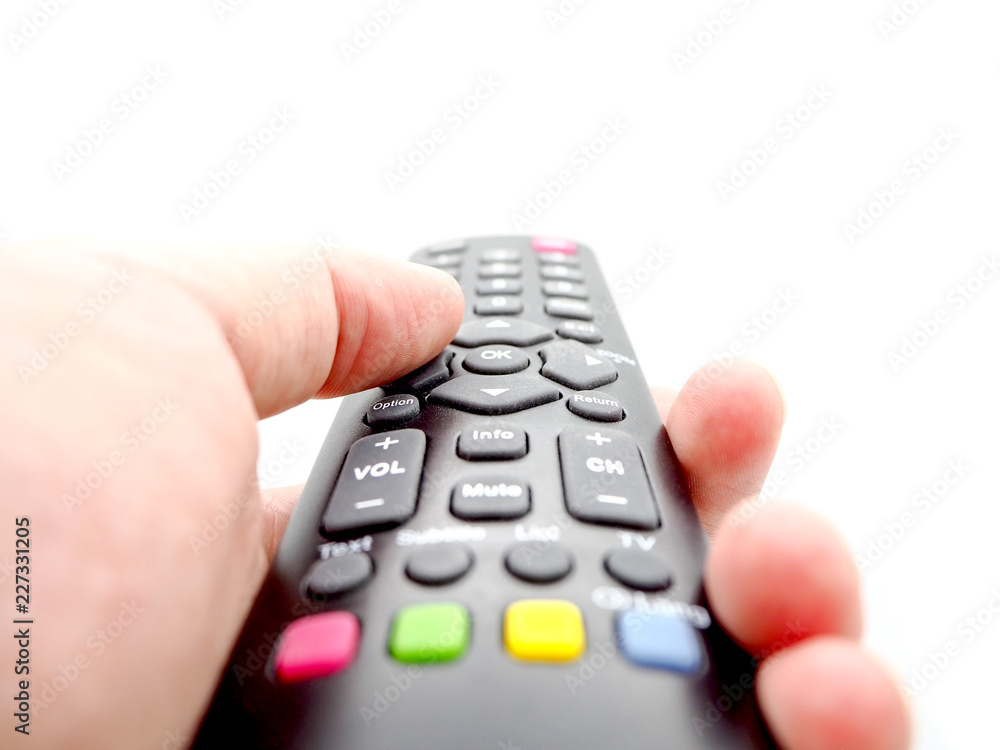 Hand holding a remote control TV isolated on white background. Hand holding a remote control TV isolated on white background.
