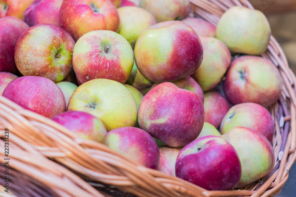 close up of red ripe apples in a basket at the farmer's market