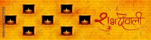 Burning diya on Diwali Holiday background for light festival of India with message in Hindi meaning Happy Dipawali