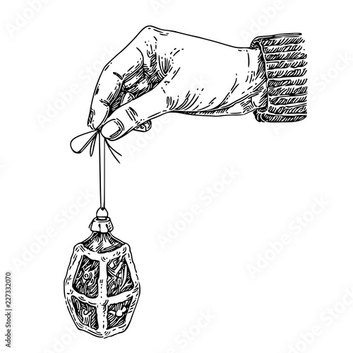 Vintage Christmas tree toy in hand. Lantern. Sketch. Engraving style. Vector illustration