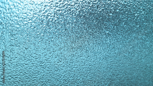 Frozen winter glass or window, abstract blue background.