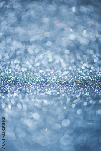 Gray or blue bokeh background of glitter lights