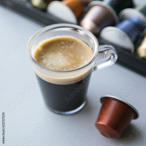 Cup of Coffee Capsule on Grey Background. Natural Light Selective Focus