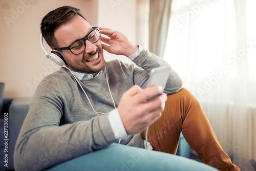 Man listening to music on headphones at home