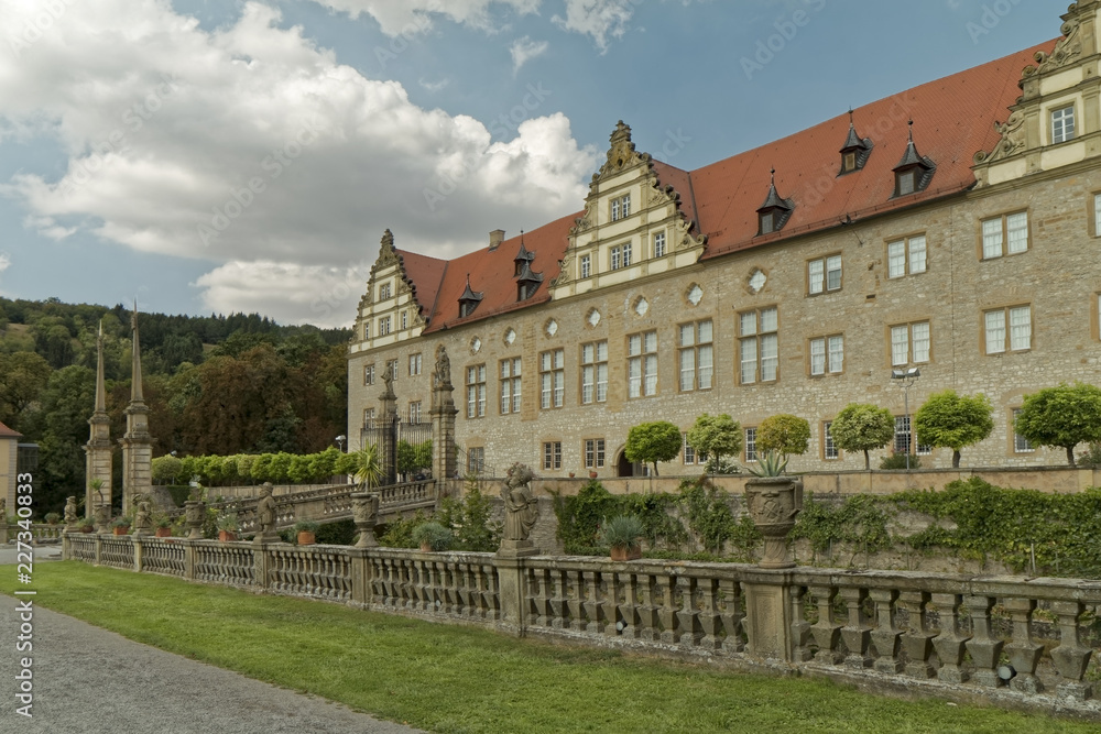 Weikersheim , Germany - view of the palace with a decorative, stone fence. Weikersheim , Germany - view of the palace with a decorative, stone fence.