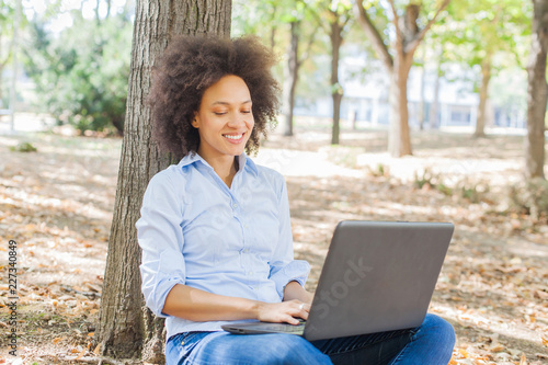Young Mixed Race Woman Student Working With Laptop In Nature