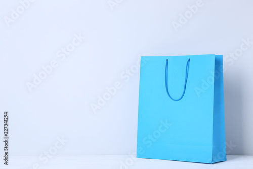 Blue shopping bag on grey background