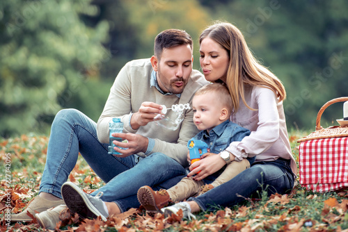 Happy family enjoying picnic in nature © ivanko80