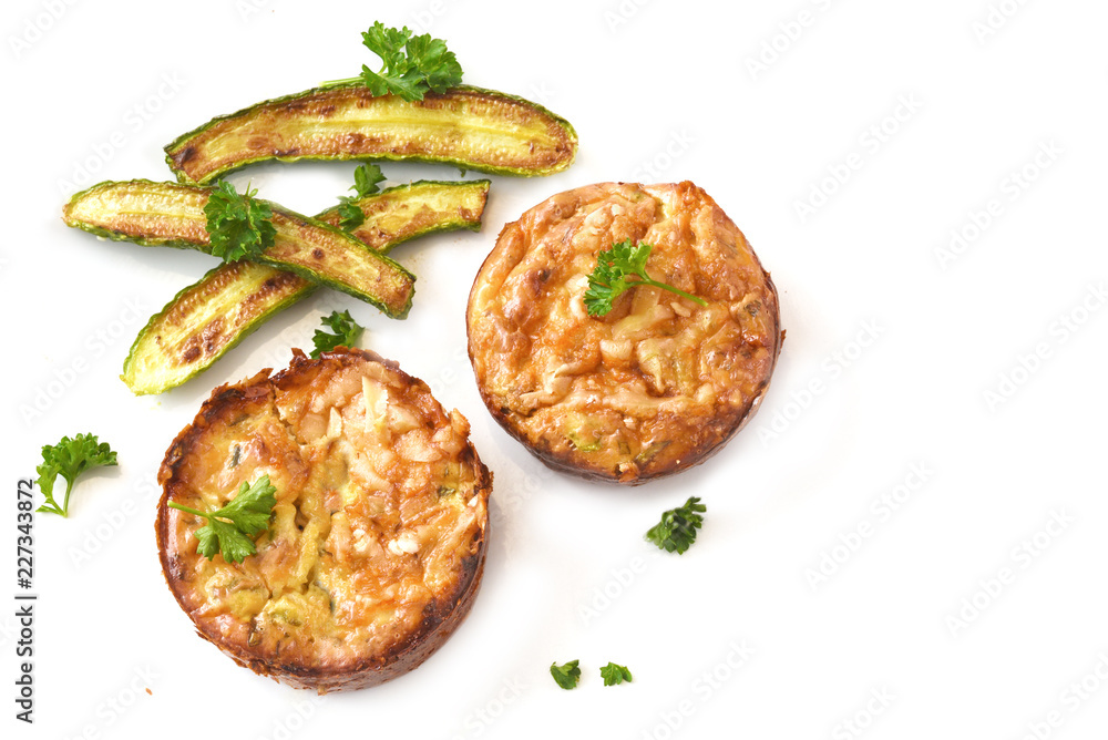 vegetable patties with roasted mini zucchini and parsley garnish isolated on a white background, copy space, high angle view from above vegetable patties with roasted mini zucchini and parsley garnish isolated on a white background, copy space, high angle view from above