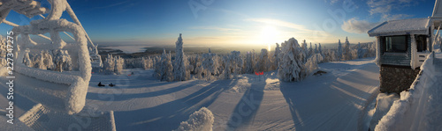 Panorama landscape covered with snow in a ski resort at sunrise. Vuokatti Finland photo