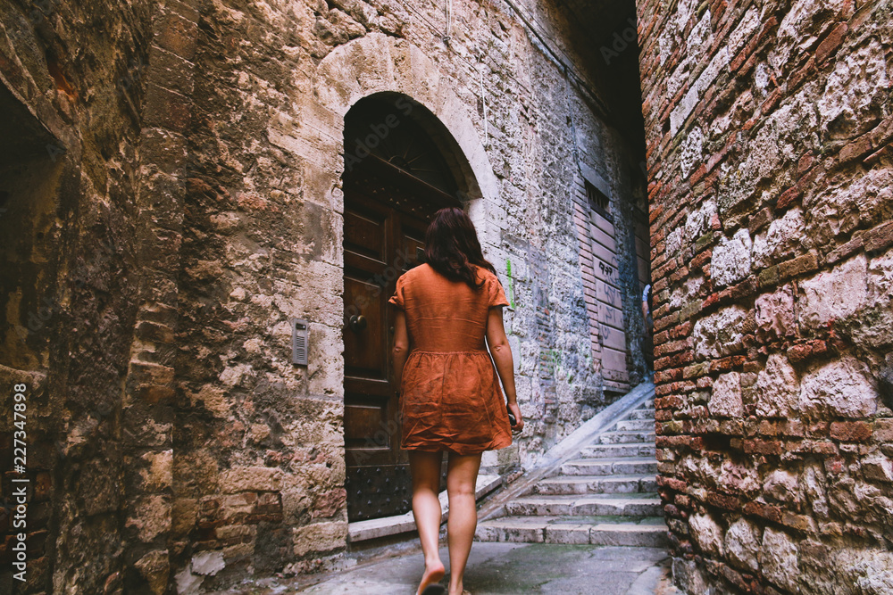 young woman in orange dress young woman in orange dress