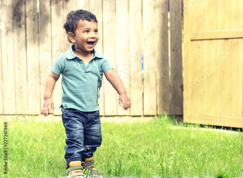 A small kid playing in graden