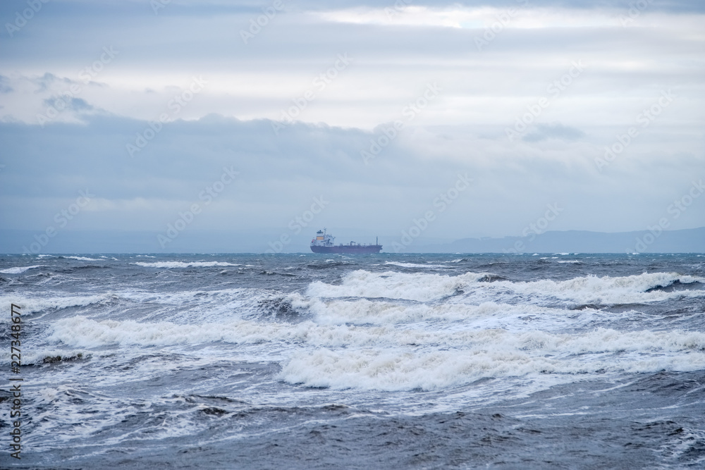 Unknown Cargo Ship sitting High on the River Clyde's Stormy Waters