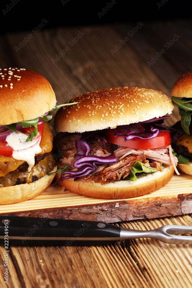 Tasty fresh meat burgers with salad and cheese. Homemade angus burger and Pulled pork sandwiches. Tasty fresh meat burgers with salad and cheese. Homemade angus burger and Pulled pork sandwiches.