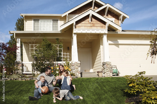 Valokuva family in front of a house