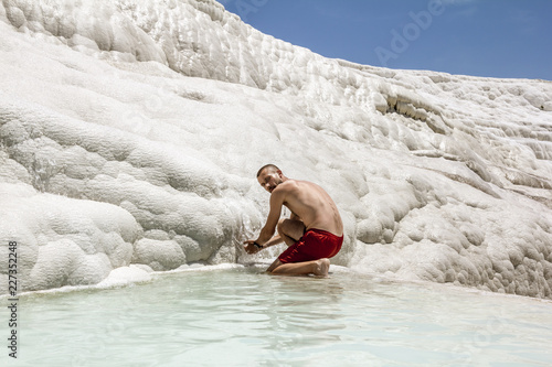 Man posing near the thermal springs and travertines of Pamukkale photo