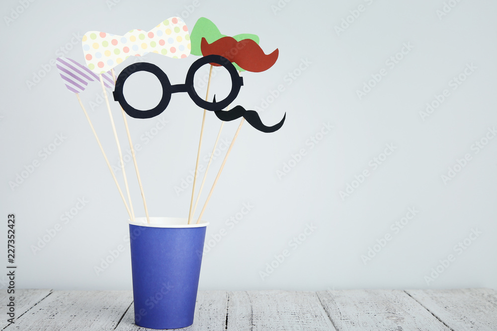 Paper booth props for party in cup on grey background Paper booth props for party in cup on grey background