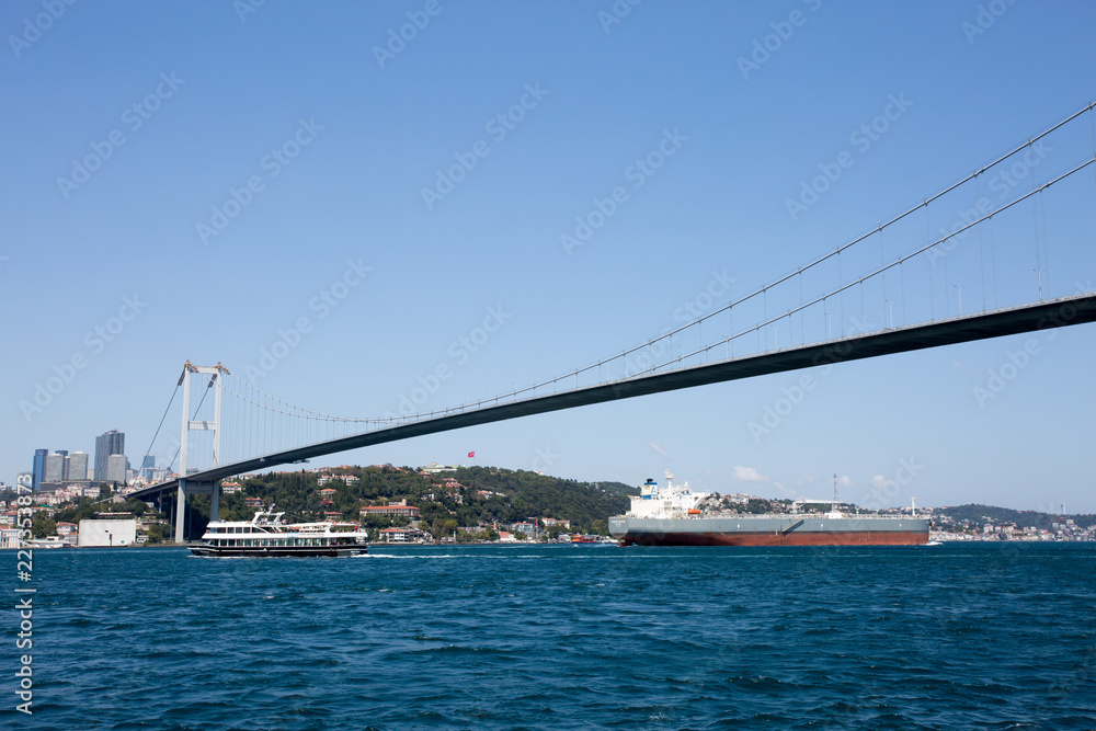 Ships pass under the bridges of the Bosphorus