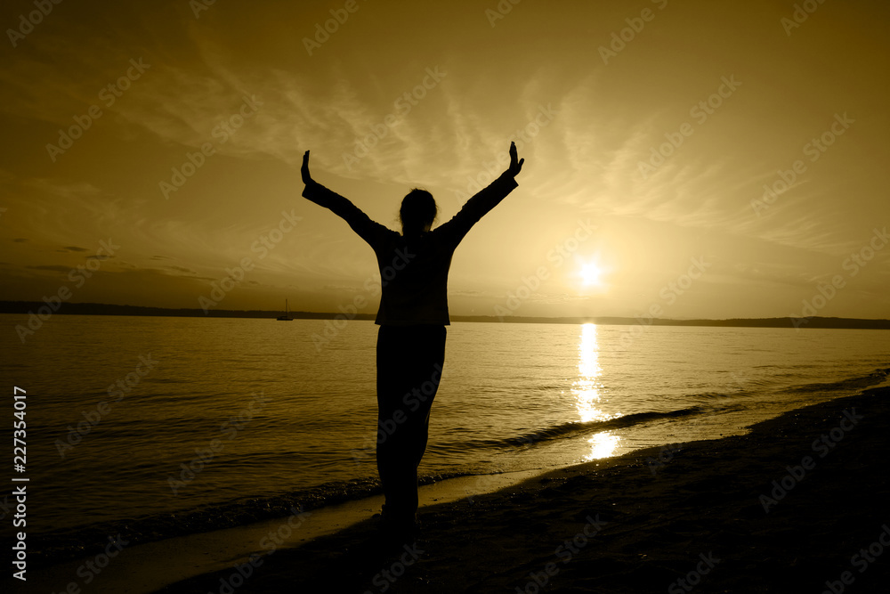 silhouette of man with open arms raised