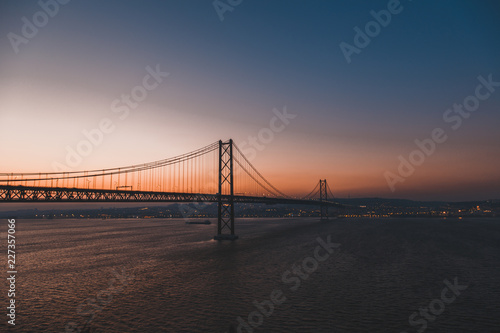 Sunset over the '25 of April' Bridge in Lisbon, Portugal.