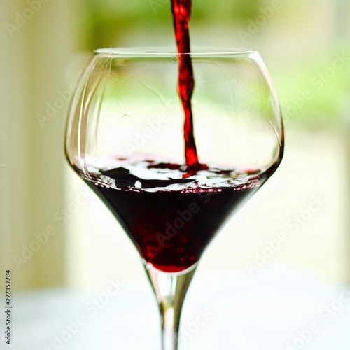 elegant glass of wine with red wine to be pored intuit with a splash