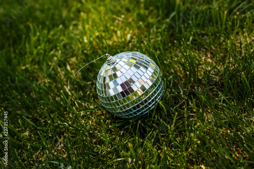 Decorative disco ball lying in the grass