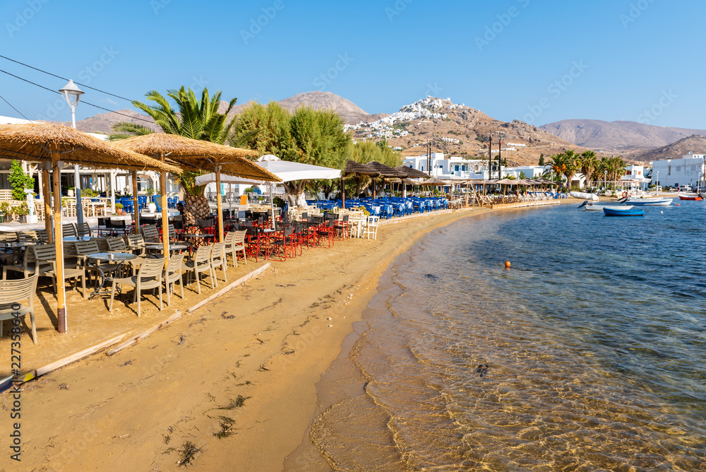 Sandy beach and greek taverns in Livadi town. Serifos island, Greece