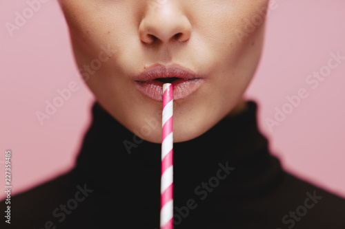 Face of a woman with straw photo