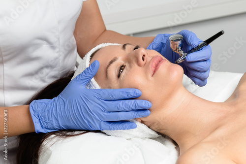 Facial beauty treatment of beautiful woman with oxygen epidermal peeling at cosmetic beauty salon.