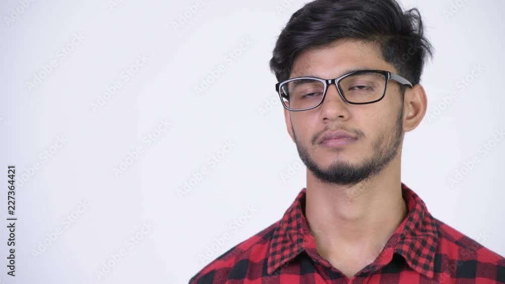 Young handsome bearded Indian hipster man thinking Young handsome bearded Indian hipster man thinking