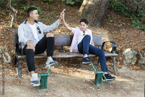 Brothers in the park at sunset.