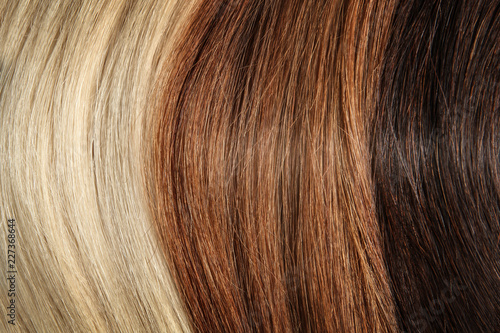 Strands of different color hair as background, closeup