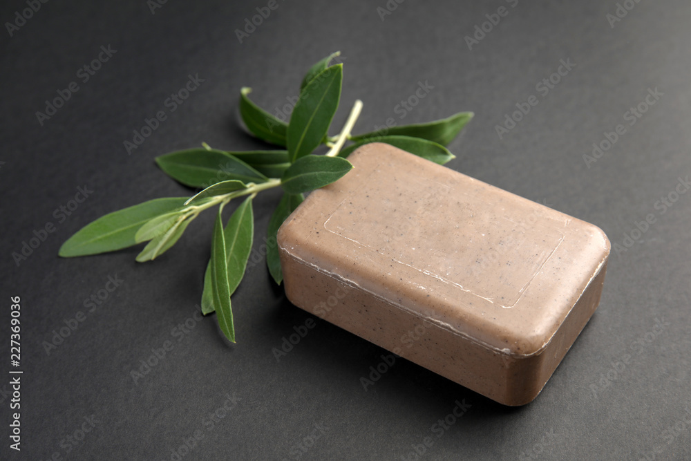 Olive twig and soap bar on black background Olive twig and soap bar on black background