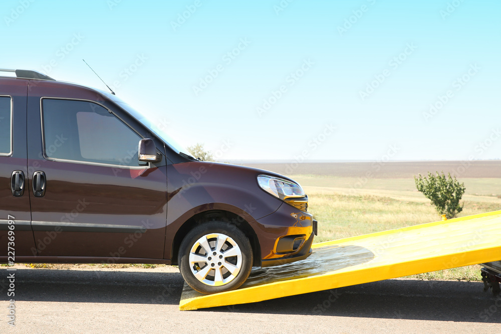 Tow truck and broken car on country road Tow truck and broken car on country road