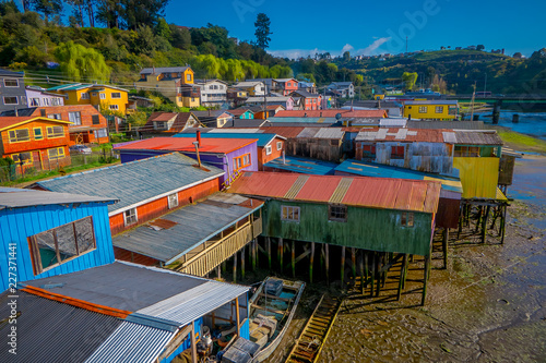 Above beautiful and colorful houses on stilts palafitos in Castro, Chiloe Island