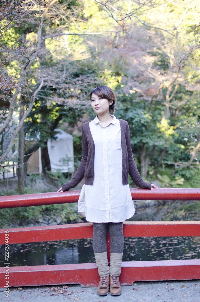 Fototapeta premium Japanese Girl poses on the street in Kamakura, Japan. Kamakura is an area located in Kanagawa where is a bit south of Tokyo.