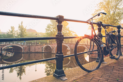 Photography Bicycle parked by Amsterdam canal