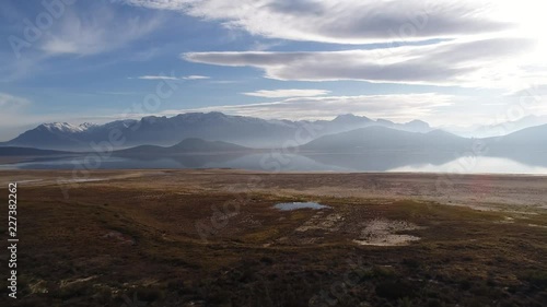 Stunning aerial views over the Brandvlei / Kwaggaskloof dam outside the town of Worcester in the western cape of south africa after a winter storm leaving snow on the Brandwaght mountains. photo