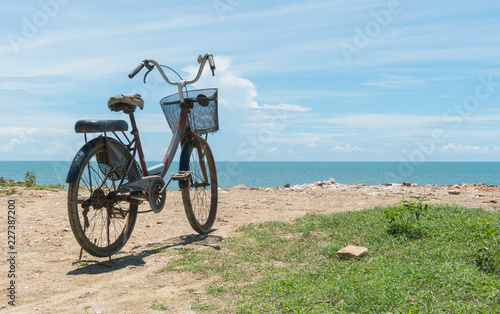 Fototapeta Naklejka Na Ścianę i Meble -  Red Bicycle on Beach and Blue Sky and Sea