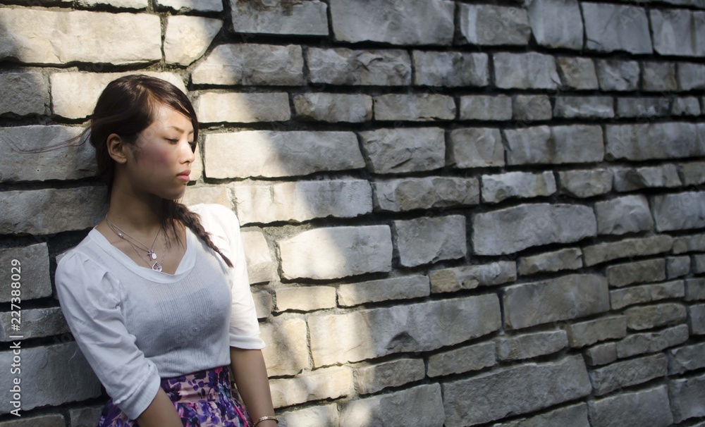 Japanese Girl poses on the street in Nakameguro, Japan. Nakameguro is a town located in the nice area of Tokyo. Japanese Girl poses on the street in Nakameguro, Japan. Nakameguro is a town located in the nice area of Tokyo.