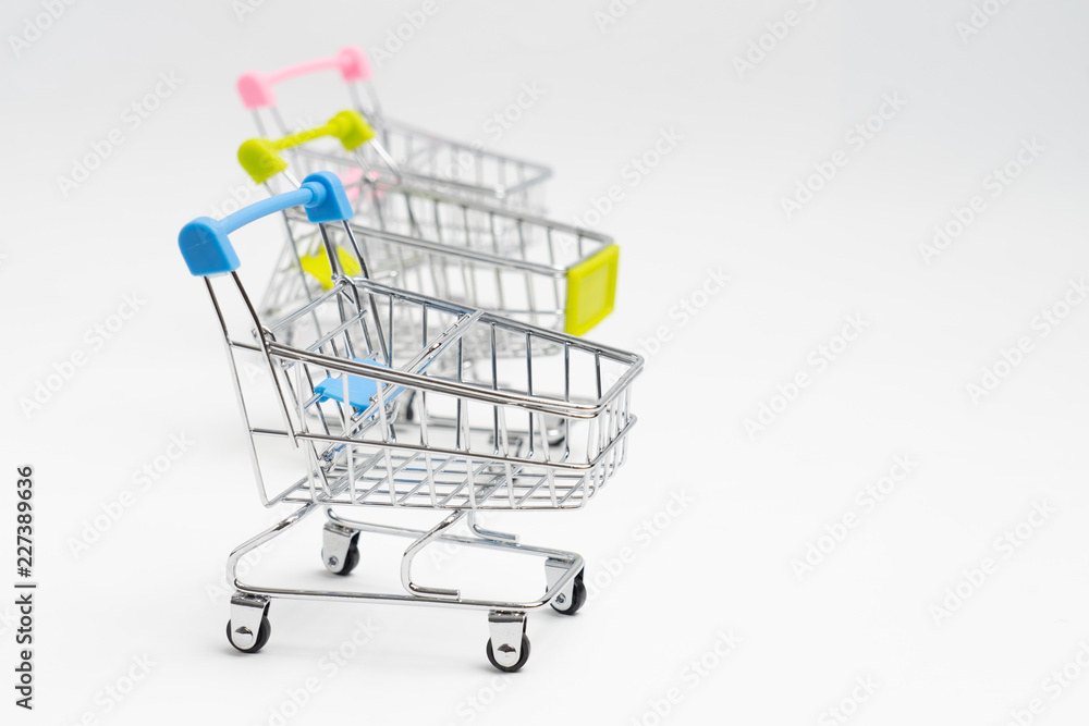 Close up of supermarket grocery push cart for shopping with black wheels on white background. Concept of shopping. Close up of supermarket grocery push cart for shopping with black wheels on white background. Concept of shopping.